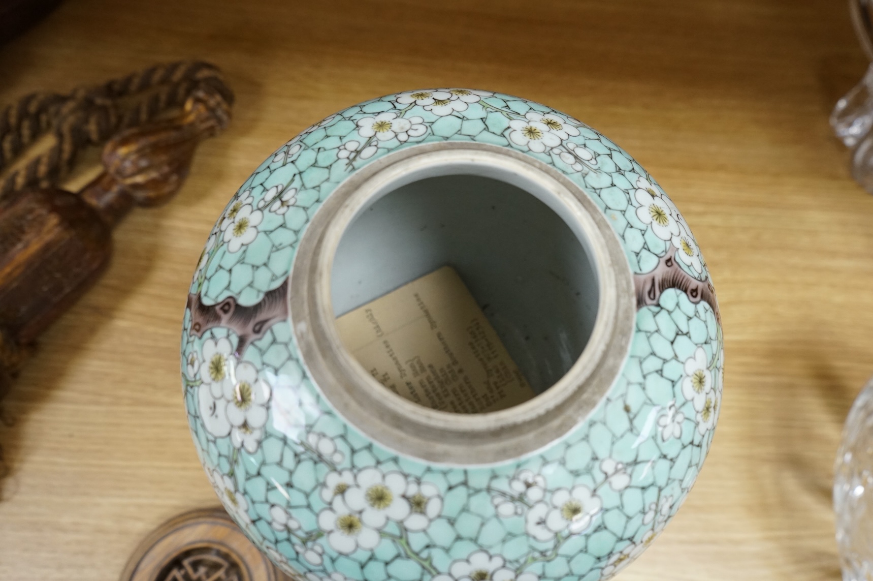A Chinese famille verte enamelled prunus jar, 19th century, with wood cover and stand, 25cm high